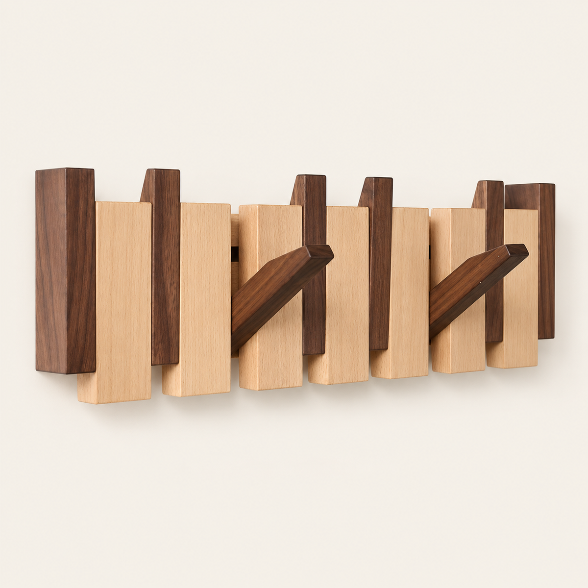 Walnut and beech Piano Hook rack from the front, two hooks folded down among the alternating keys — Wood Store NZ