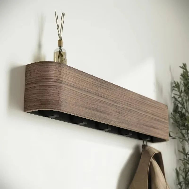 Top shelf of the wall rack holding a diffuser and keys