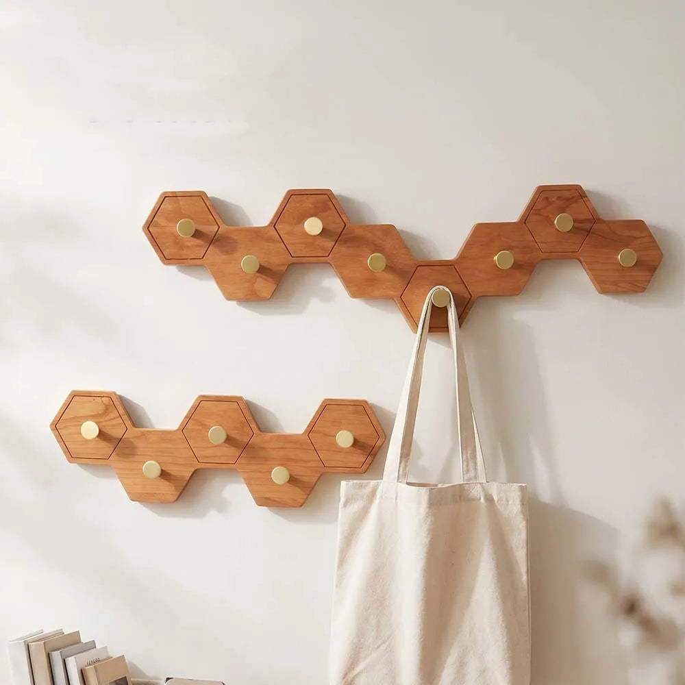 Hexagonal honeycomb hook rack mounted in an entryway